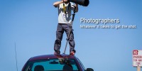 Photographer standing on a car to get the shot